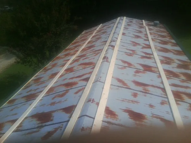 Rusted metal roof panels with new wood purlins before replacement — Storm Damage Roof Repair in Leonardtown by Roofing Brothers