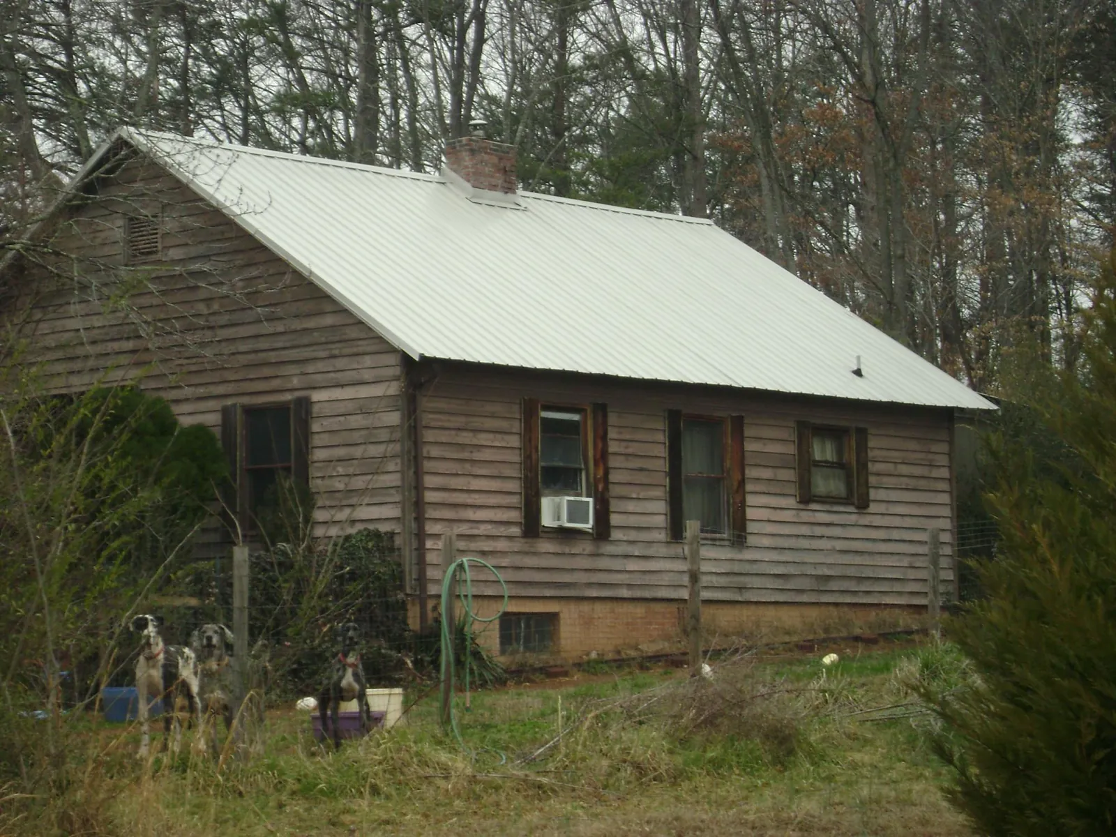 White metal roof on an old wood sided farmhouse, from a Asphalt Shingle Roof Repair job in Leonardtown